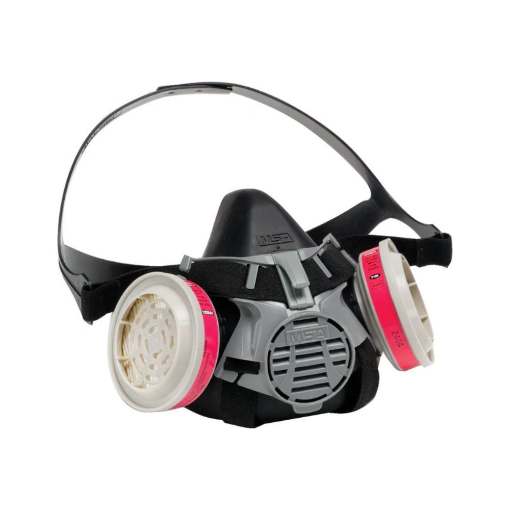 MSA Advantage 420 half-mask respirator in black, fitted with dual pink and white filter cartridges for reliable protection against dust, fumes, and gases.