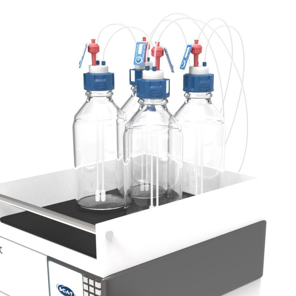 Glass laboratory bottles fitted with SCAT safety caps and tubing for secure solvent supply and waste management.
