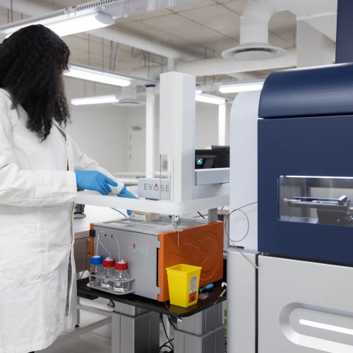 Scientist operating Evosep One instrument in a modern laboratory